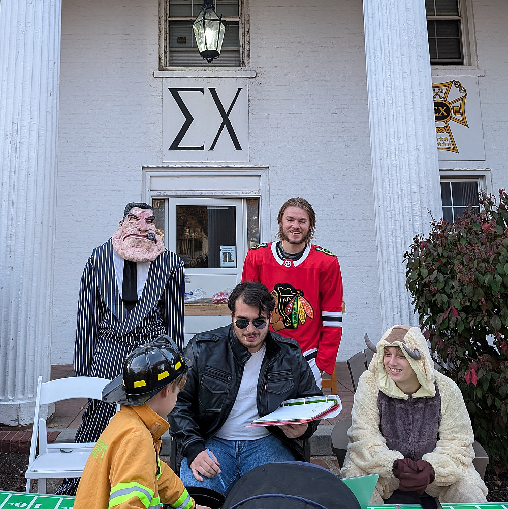 halloween at sigma chi Sigma Chi members greet trick or treaters in costume.