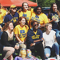 Members of Theta Pi Gamma tailgate at the Homecoming football game against Cornell College.
