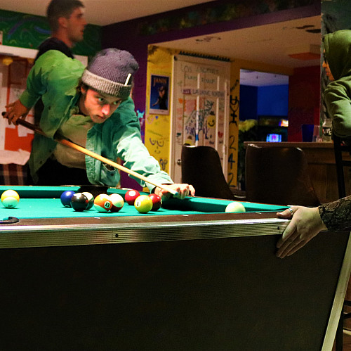 Students playing billiards at C-Haus.
