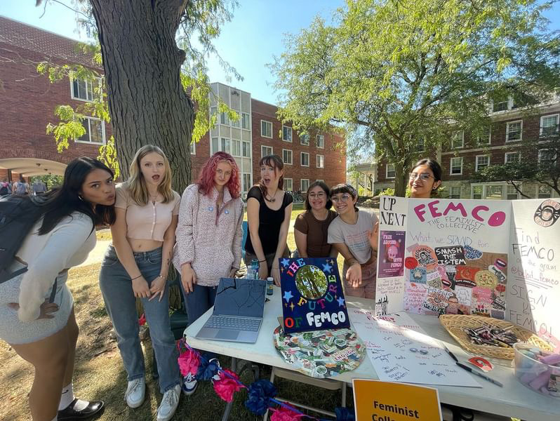 Members of Fem Co at Involvement Fair table.