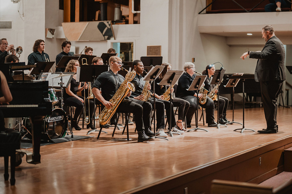 A student music ensemble performing on stage.