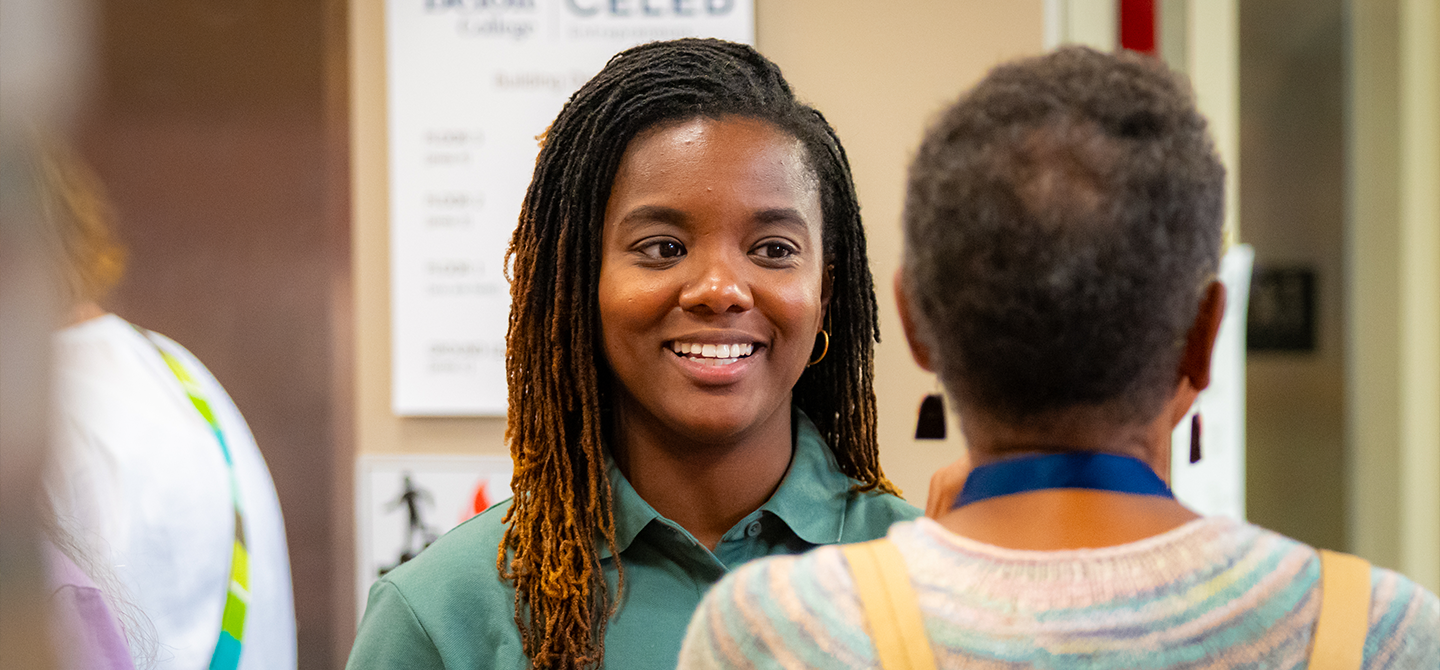 A student talking with a faculty member.