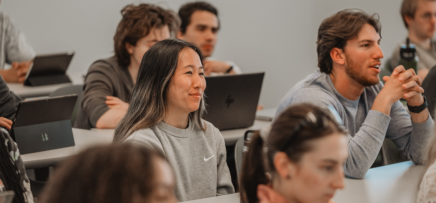Students listening intently during a class presentation.