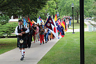 Beloit College kicks off the fall semester with a colorful parade that includes all the international flags of first-year students as they march down College Street to the convocation ceremonies at Eaton Chapel.
