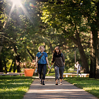 Beloit College students walk down one of the park-like walkways in the Beloit College campus.