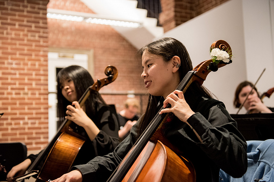 Members of a music department's strings group performs a concert in the Wright Museum's Courtyard Gallery.