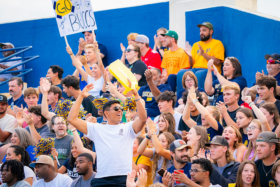 A crowd cheers on the Bucs at the Homecoming football game.