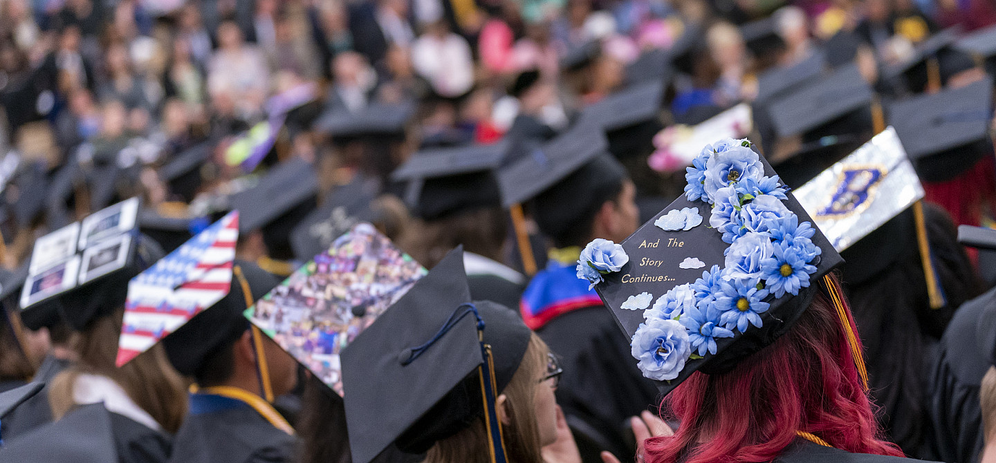 Students in decorated caps during Commencement.