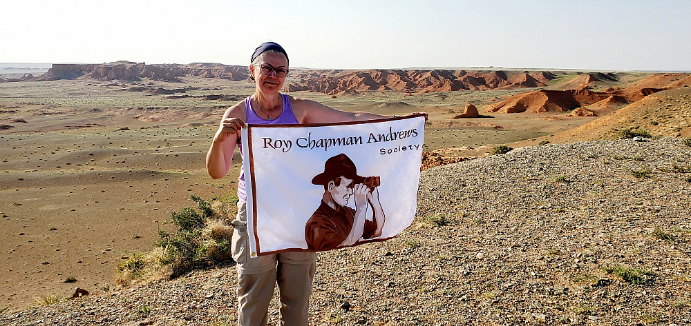 Shannon Fie displays the Roy Chapman Andrews Society flag.