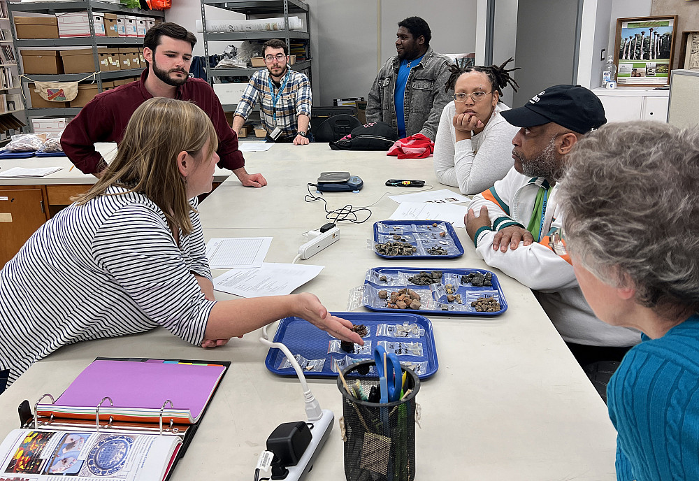 Volunteers sort artifacts.