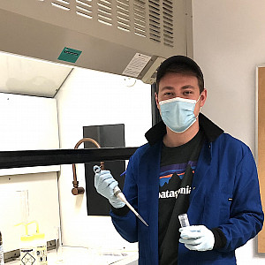 Jonathan Palmer ’19 in the chemistry lab holding pipet and vial