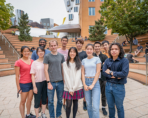 Jerry (at right) with fellow researches and the lab PI at MIT