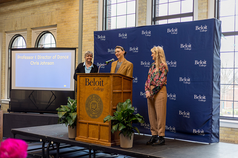 Gina T'ai reads the emeriti citation for Chris Johnson during the 2025 Faculty Staff Recognition ceremony.