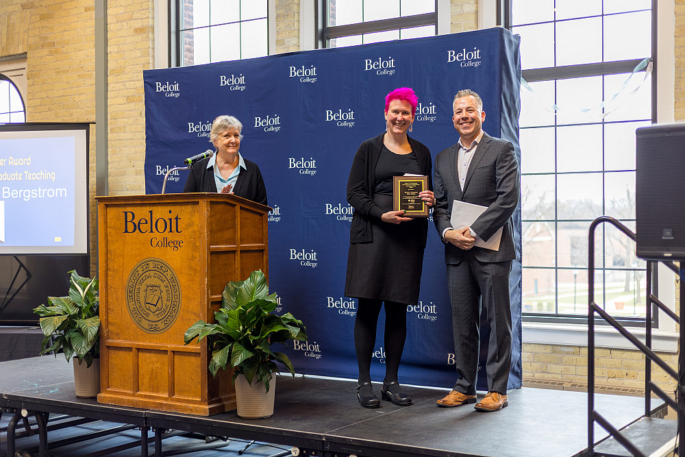 Rachel Bergstrom holds the Underkolfler prize alongside an Alliant Energy representative during the 2025 Faculty Staff Recognition ceremony.