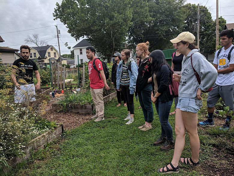                                    Kaelyb Lokrantz, Merrill Community Garden Coordinator, giving a tour of the garden to Jingijng Lou's c...