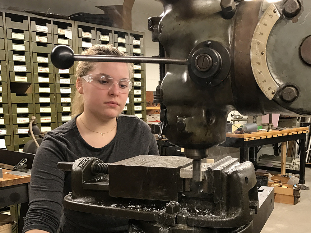 A student works with a milling machine in the Physics Machine Shop in the Science Center.