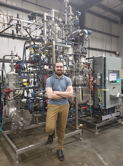 Dakotah Revai in front of a system he recently designed.