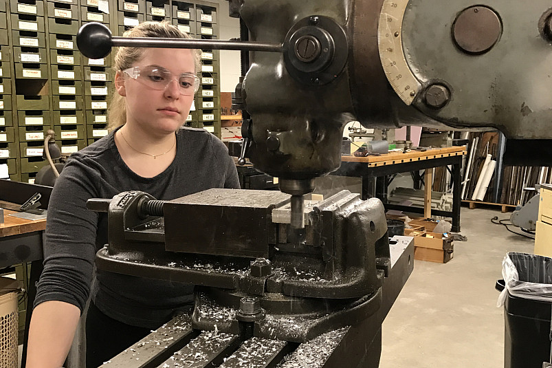 A student works with a milling machine in the Physics Machine Shop in the Science Center.