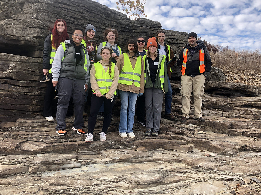 Beloit students standing together in a geological feature.