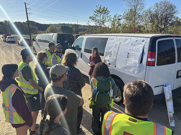 Beloit College student, Lia Dirks '27, presents a poster of her research on the stratigraphy of the Eau Claire Formation to field trip pa...