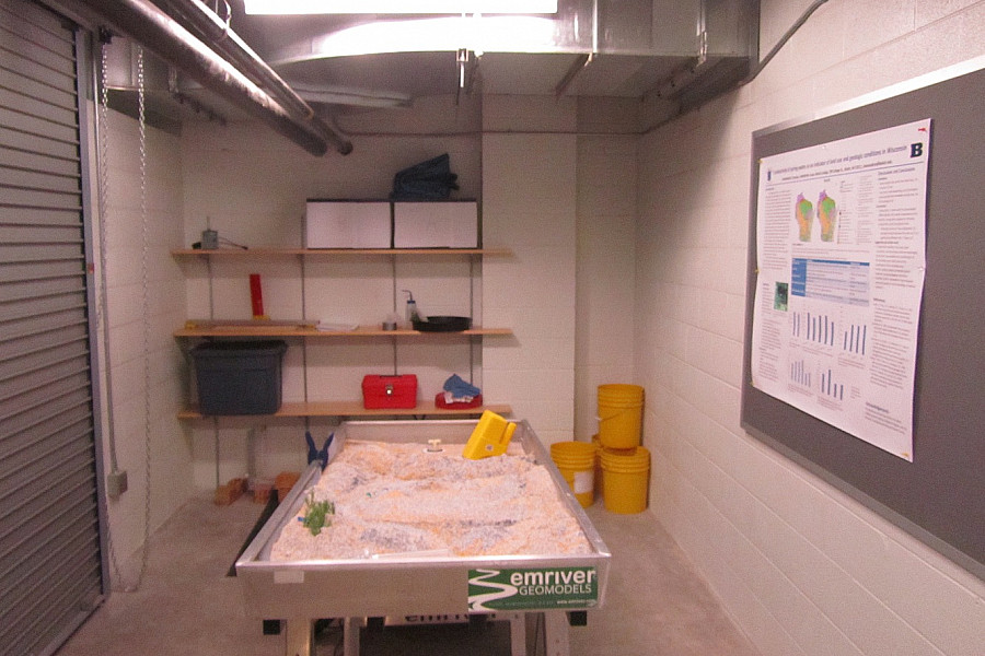 Geology students visualize fluvial processes with the Geology Department's stream table.