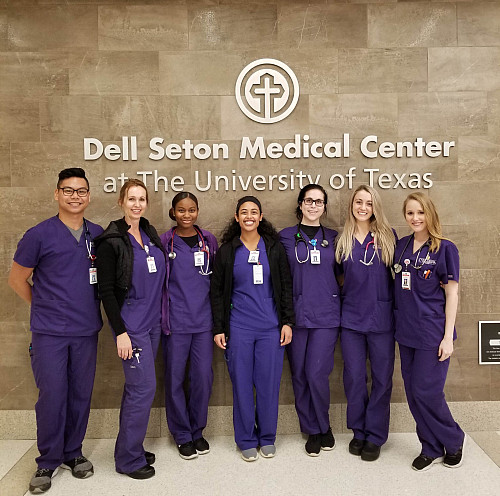 Lucia Peralta'12, center, with colleagues at Dell Seton Medical Center