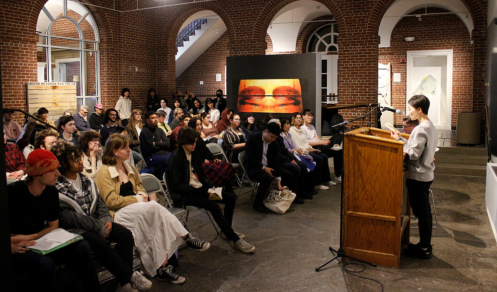 Author Kaori Fujino reads excerpts from her novella Nails and Eyes to a packed crowd in the Wright Museum of Art courtyard.