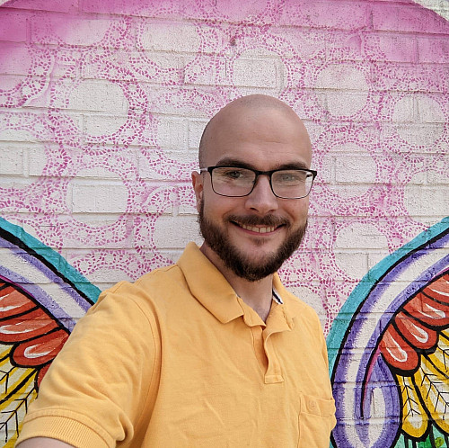 Mark Anderson'17 with mural in background