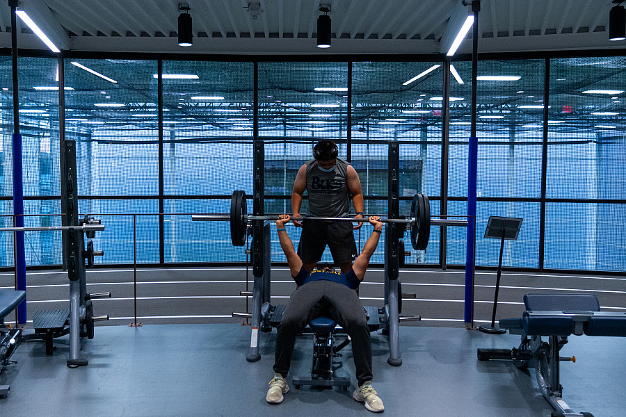 Two students lifting on the fitness floor of the Powerhouse.