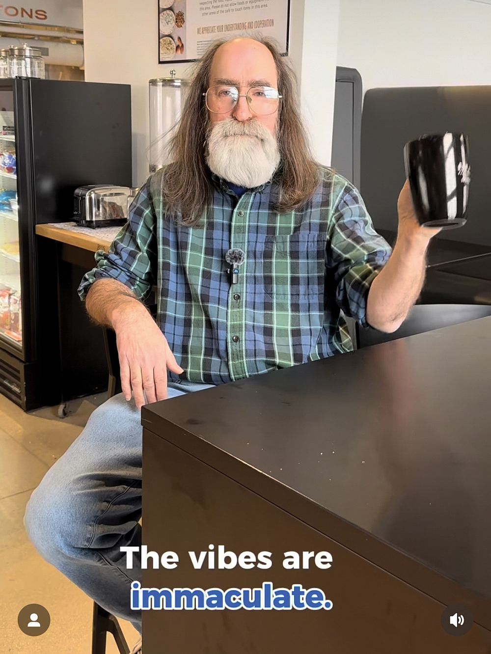 Archivist Emeritus Fred Burwell '86 holding a mug, a caption says The vibes are immaculate.