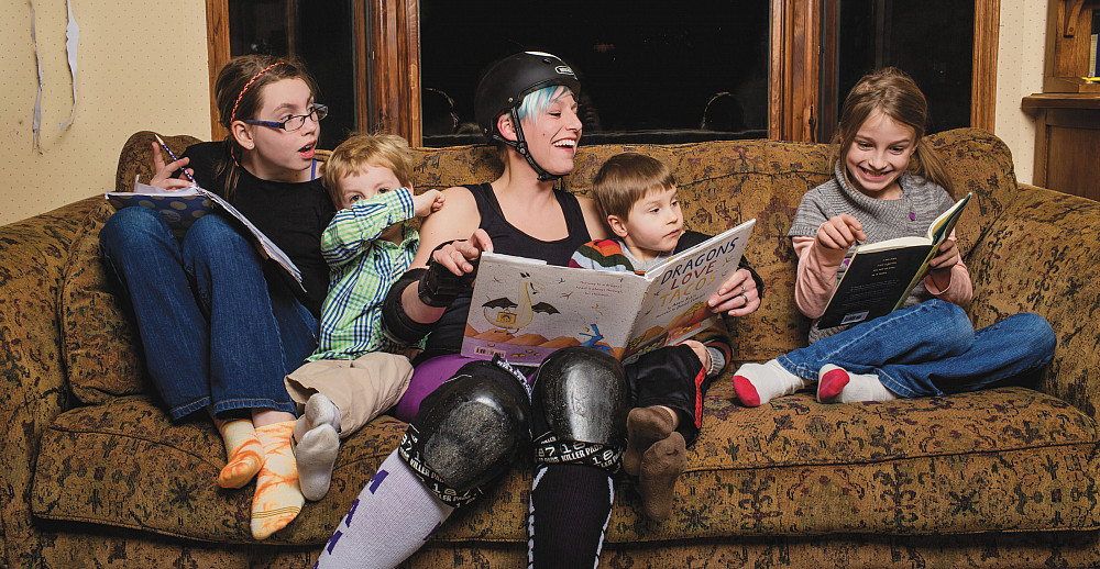 Jessica Gray Jagoditsh'00 is surrounded by her kids in the family's Stevens Point, Wis., home. From left are Daisy, Zeb, Jessica, Dexter,...