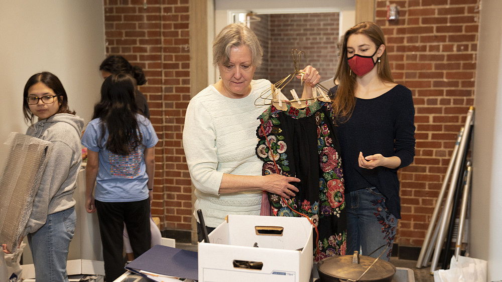 Professor Donna Oliver and India Clizer'24 organize traditional Slovak aprons collected by Director Emerita of International Education Be...
