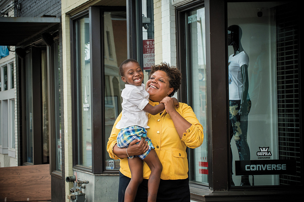 Snowden with her son Malik in the Anacostia neighborhood of D.C. She cites him as her inspiration for accepting the post of the deputy mayor.
