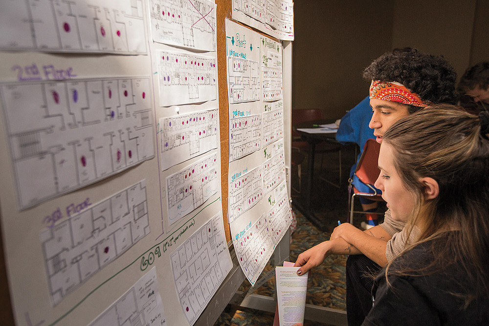 Students weigh their room options from floor plans posted in Pearsons Hall during the room lottery. Choices are ruled by a combination of...