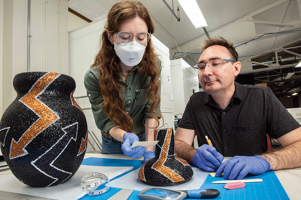 Emily Starck'14 and Jamie Kelly'96 examine a contemporary ceramic piece.