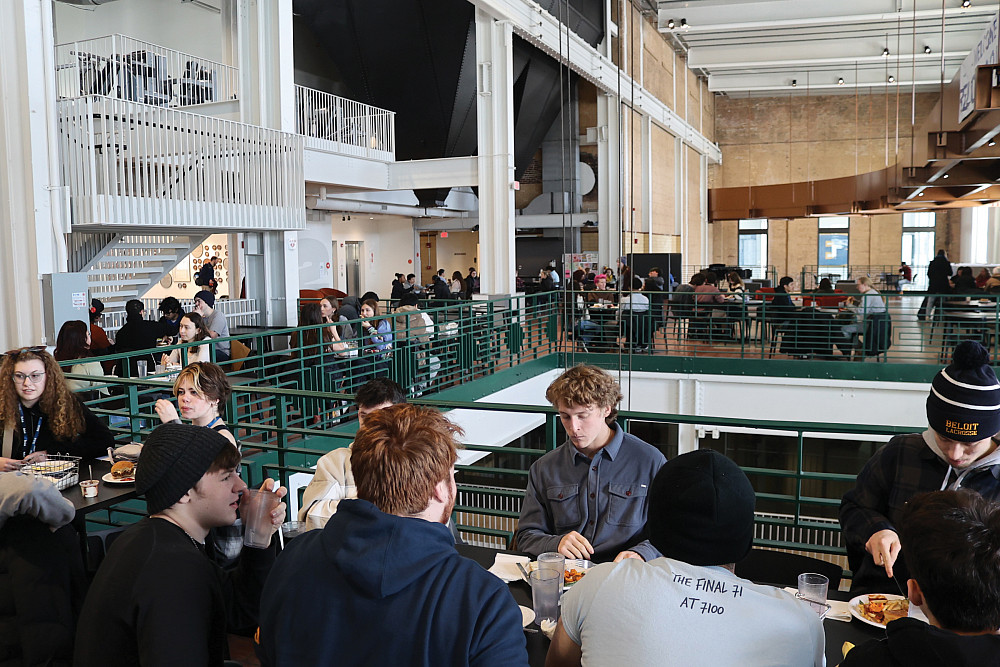 Students eating together throughout the spaces in the Powerhouse.