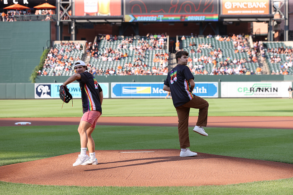 Cole Philpott and Aiden Phipps '25 throw the first pitch.