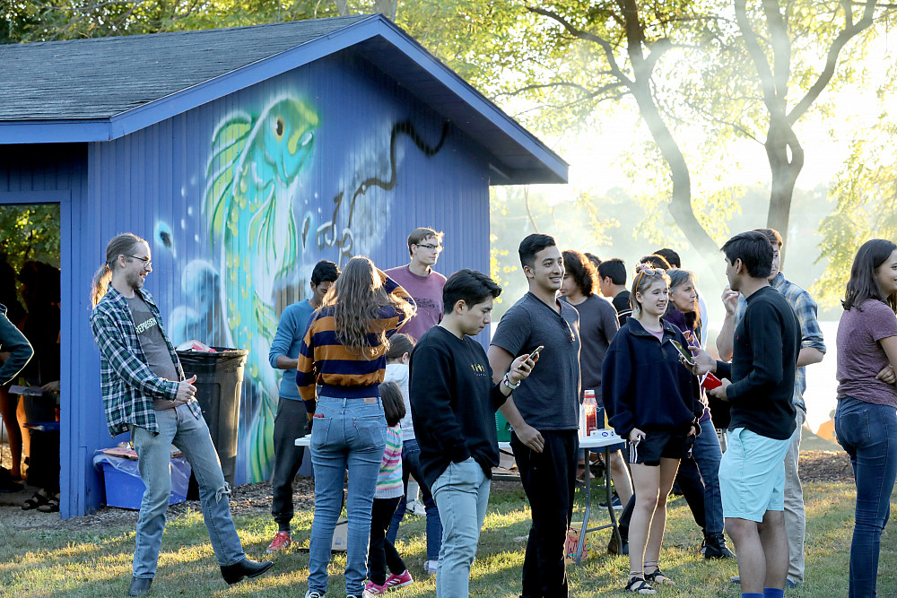 A crowd gathers at Buccaneer Boathouse property for a cookout and bonfire.