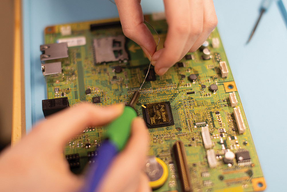 Working with a circuit board at CELEB, Beloit's Center for Entrepreneurship