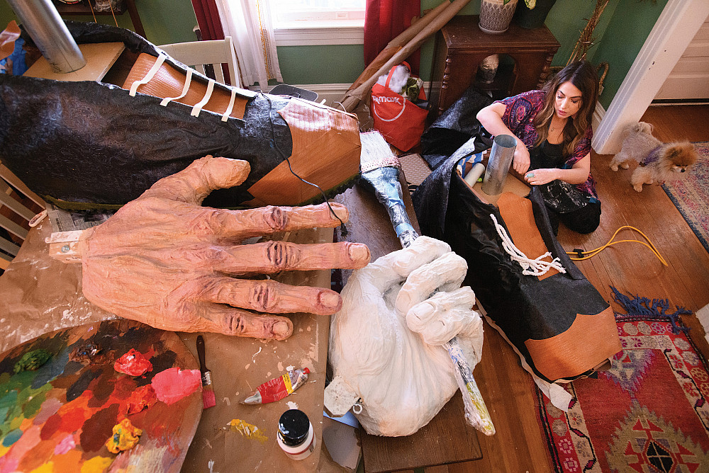 Rockey: Hands, Feet, and Scale The puppet's shoes and hands dwarf Sofia Hernandez Crade'13 and her dog.