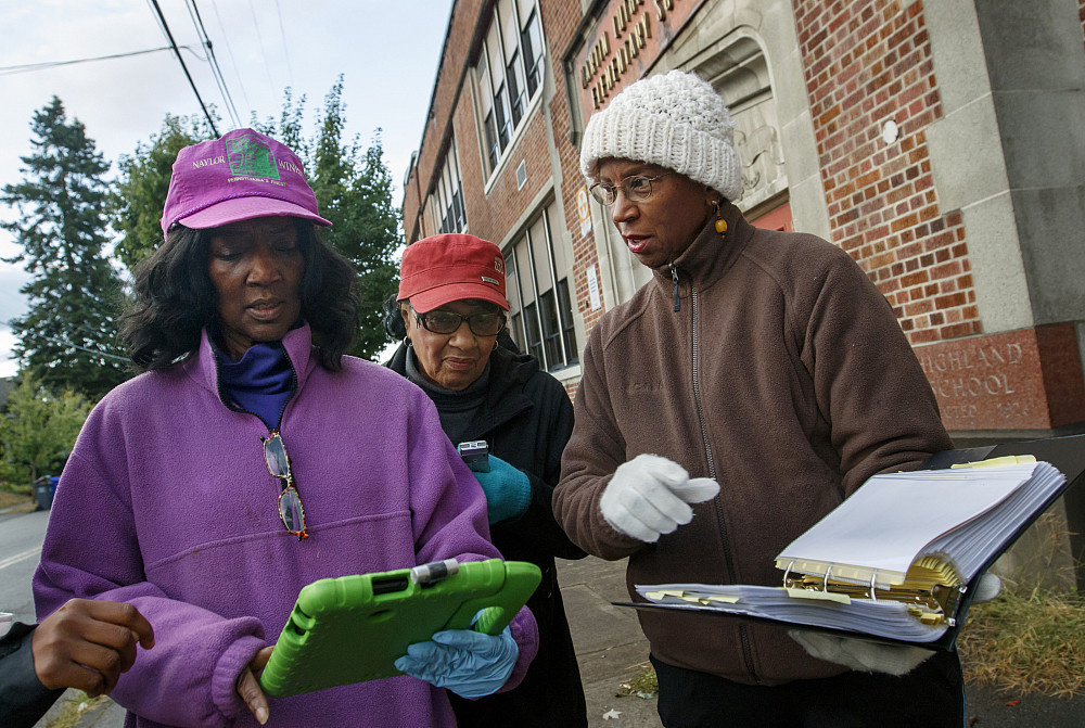 (Left to right) Vickie Naylor, Bernadine Clay, and Donna Maxey look over the walking route as they take part in the Sharing History throu...