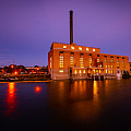 The Powerhouse under construction at dusk, lights shining through the building's windows.