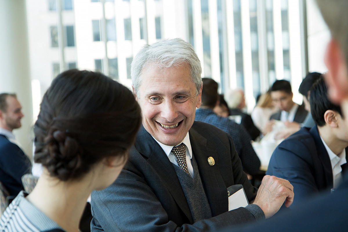 President Scott Bierman speaks with a student during an Econ Day event.