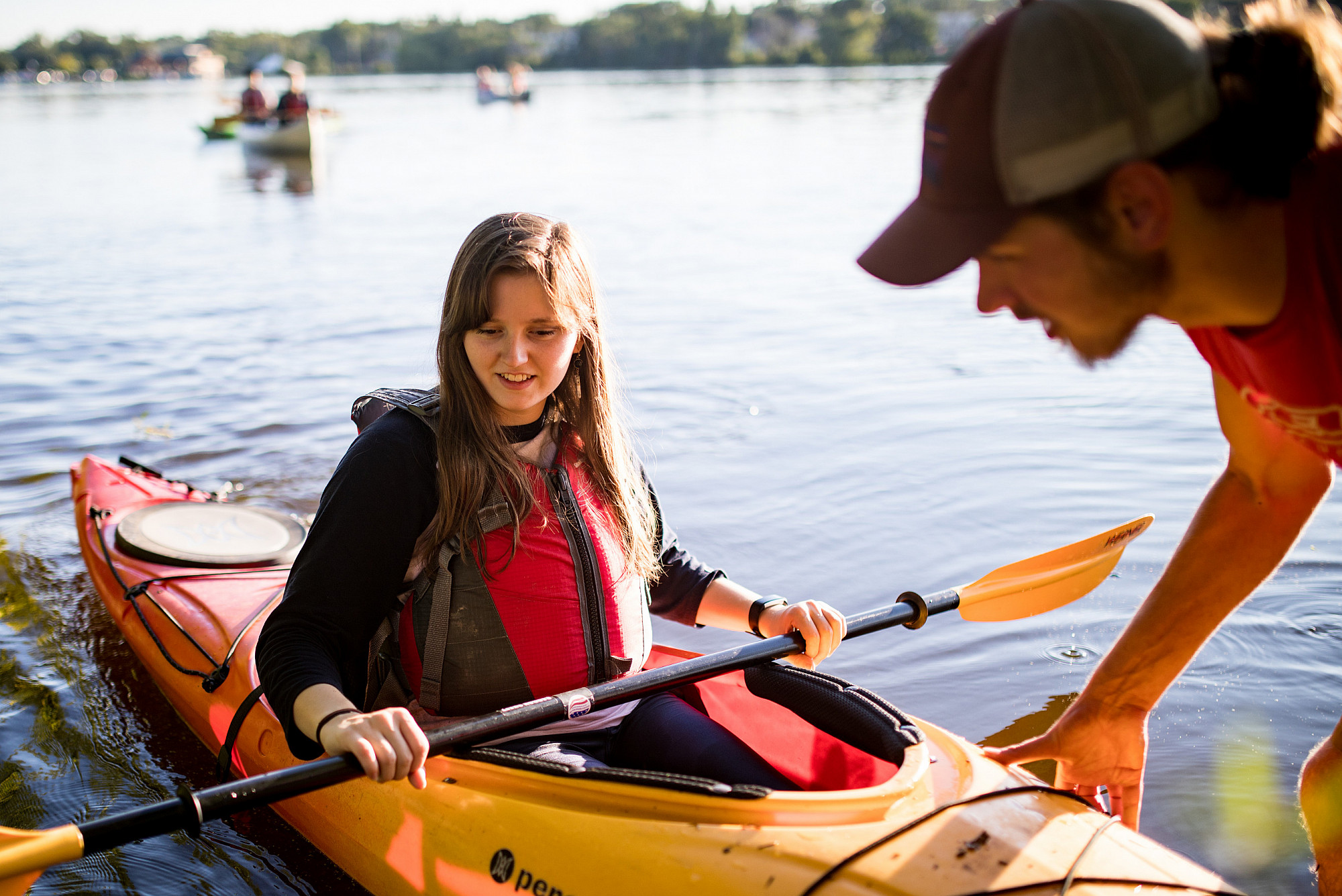 Students prepare to launch a kayak during a Buccaneer Boathouse event on the Rock River.