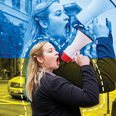 Anastasia Voronovsky’21 uses a megaphone in an urban setting.
