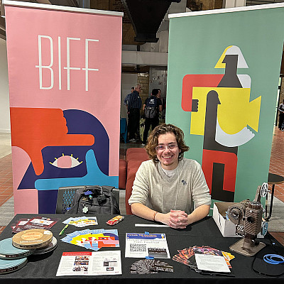 Nico Doret'24 at a booth for the Beloit International Film Festival