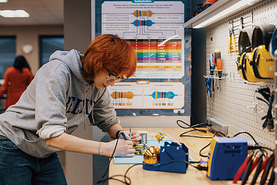 Maker Lab supervisor Adwyn Burdett'27 experiments with a motherboard.