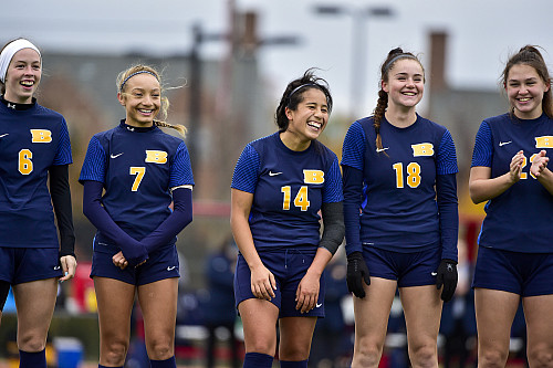 Lorraine Pedroza'24 (center) is introduced before the game against Washington University in St. Louis.