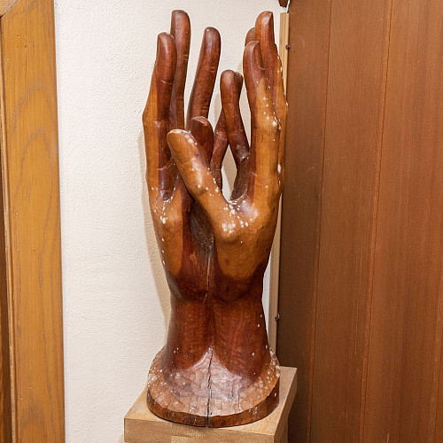 Supplication, a cherry wood sculpture of hands outstretched in prayer, was created by an artist named Anton Grauel and donated anonymousl...