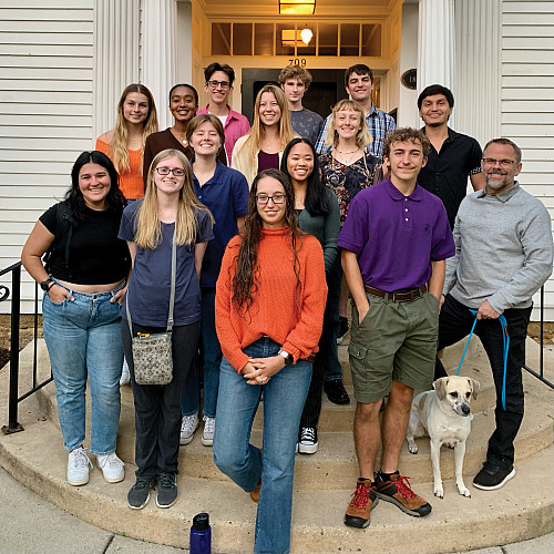 Cross-country team stands outside the President's House with President Eric Boynton.